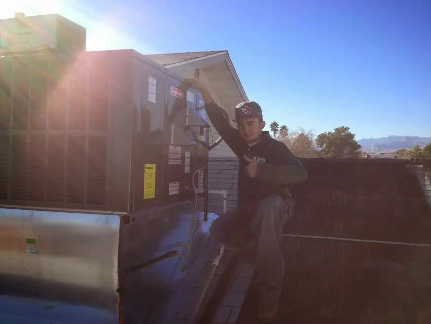 HVAC technician performing Air Duct Repair on a rooftop unit in Difficult Run